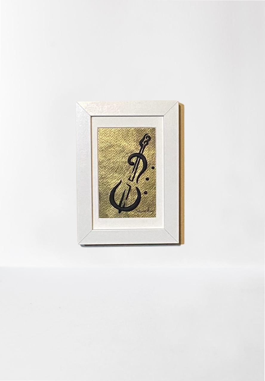 Handmade wall frame, featuring a 3D cello crafted with polymer clay on a golden painted canvas. The frame is white and made of wood.